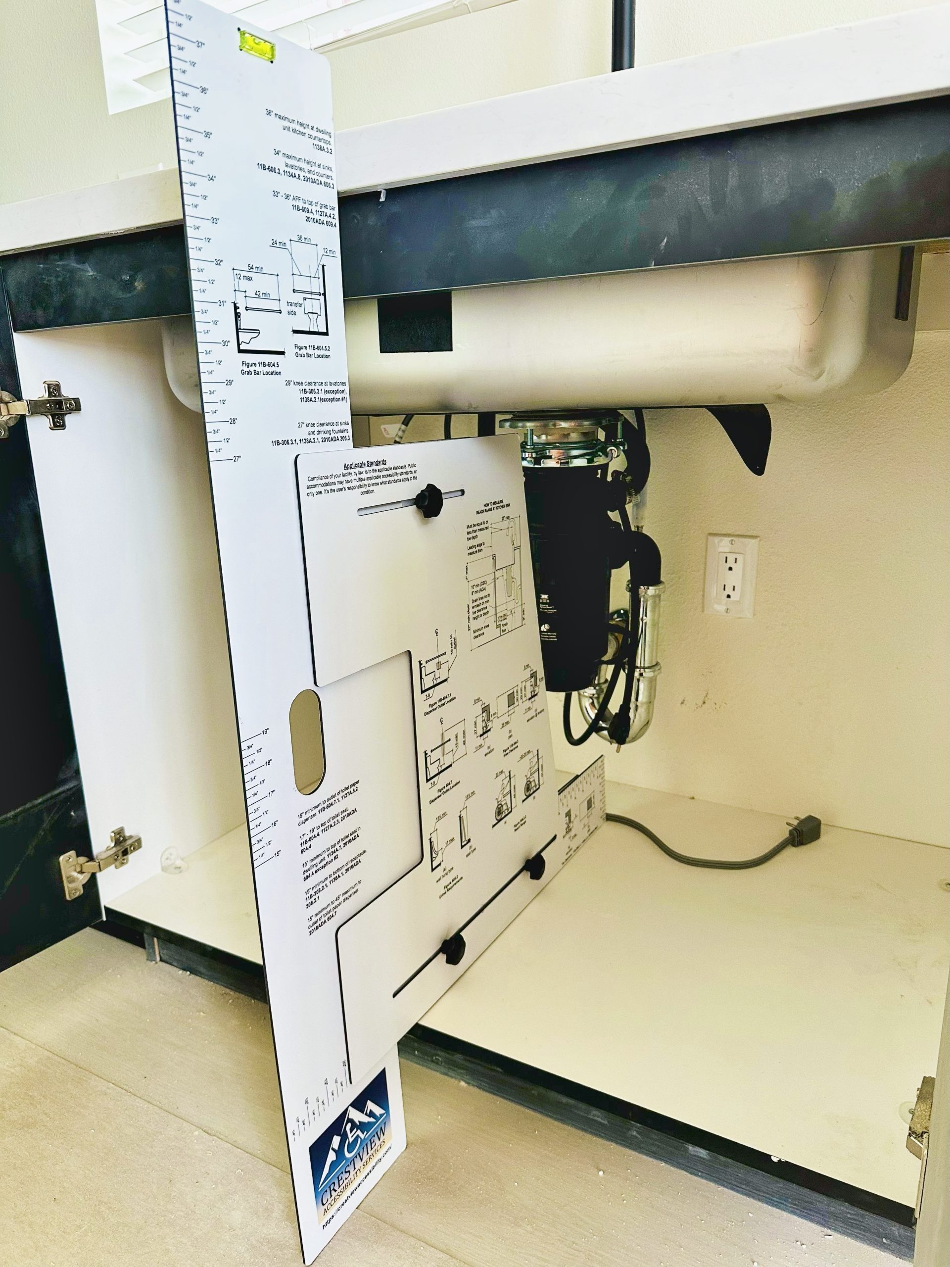 Device for measuring accessibility clearances and reach ranges.