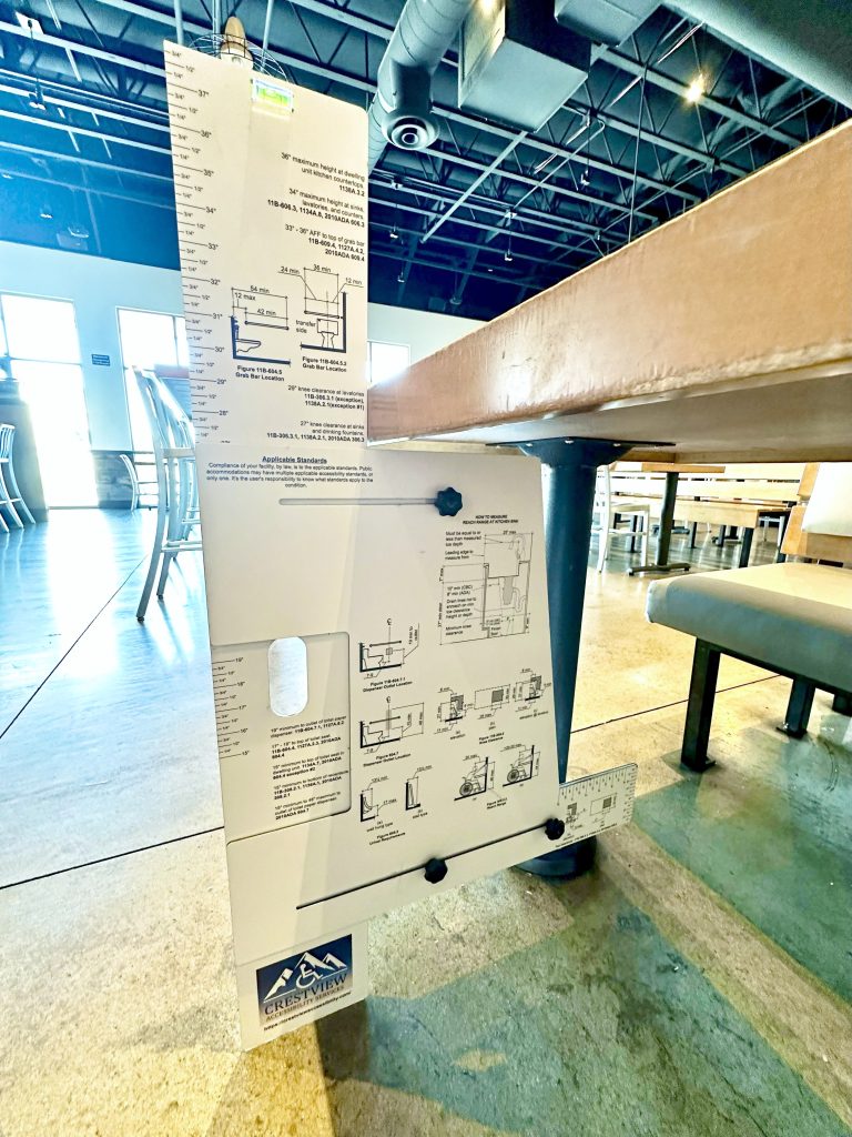 Device for measuring accessibility clearances and reach ranges.
